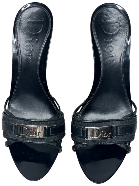 CHEZ SNOW BUNNY Dior black leather mules with silver-tone logo hardware and kitten heels, top-down view.