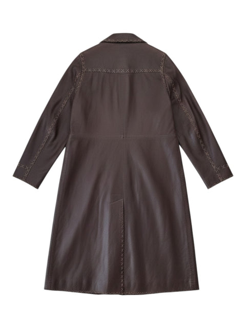 Back view of a CHEZ SNOW BUNNY brown leather coat featuring decorative cross-stitch detailing along the seams.
